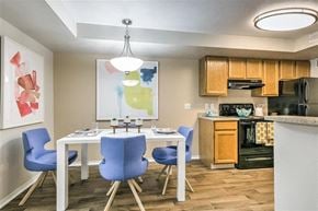 Boise apartment for rent - A kitchen with a table and chairs and a painting on the wall.