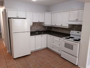 Hamilton apartment for rent - an empty kitchen with white appliances and white cabinets