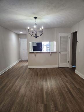 Columbus apartment for rent - A room with wooden floors and a chandelier.