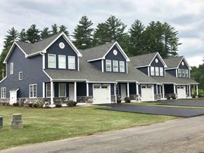 Pembroke apartment for rent - a large house with white garage doors and a lawn