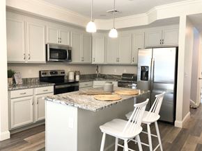 Pembroke apartment for rent - a kitchen with white cabinets and a counter top