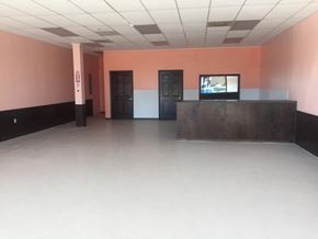 Mesquite apartment for rent - A room with a television on a stand and two doors.