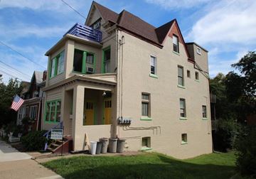 Pittsburgh apartment for rent - a white house with green windows and a roof