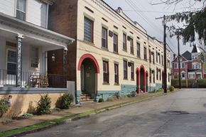 Wilkinsburg apartment for rent - A row of houses with red arched doorways.