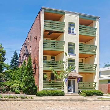 Pittsburgh apartment for rent - A building with a red brick facade and green balconies.