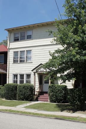 Pittsburgh apartment for rent - A white house with a red roof and a tree in front.