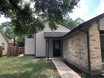 Houston house for rent - a white house with a sidewalk and a brick wall