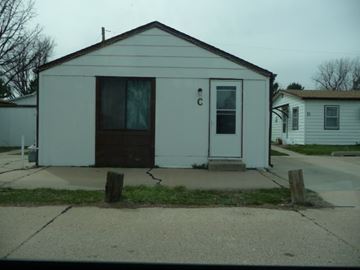 Kearney apartment for rent - a small white house sitting on the side of a street