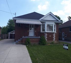 Hamilton apartment for rent - a small brick house with a sidewalk in front of it