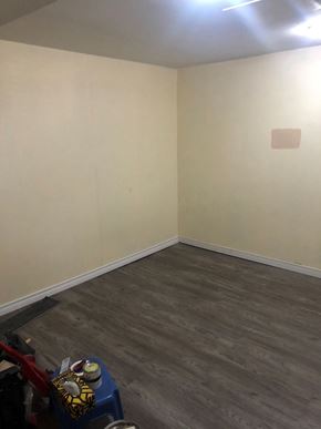 Hamilton apartment for rent - a room with white walls and a wood floor