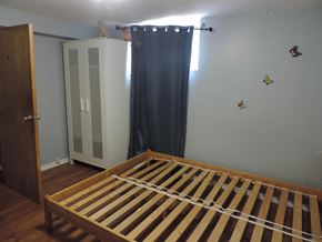 Hamilton apartment for rent - a bedroom with a bed and a closet and a curtain