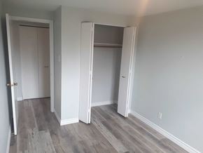 Waterloo apartment for rent - a bedroom with white walls and wood floors and a closet