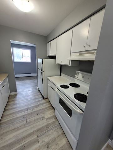Waterloo apartment for rent - A kitchen with a white stove top oven and white cabinets.