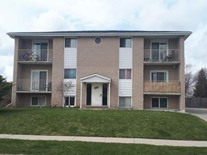 Waterloo apartment for rent - the front of a brick apartment building with a lawn