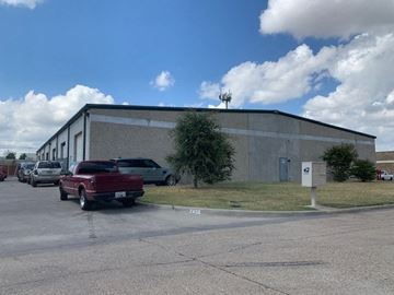 Garland apartment for rent - A building with a parking lot in front of it.
