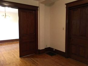 Kitchener apartment for rent - an empty room with two doors and a wood floor