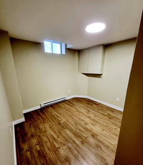 Ottawa apartment for rent - an empty living room with wood flooring and a window