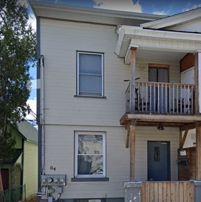 Ottawa apartment for rent - a white house with a balcony and a blue door