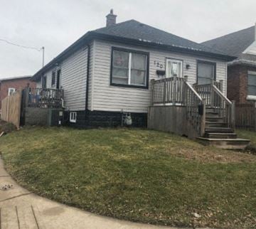 Hamilton house for rent - a white house with a yard and stairs