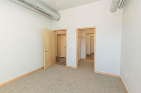 South Sioux City apartment for rent - a room with white walls and a carpeted floor and two doors