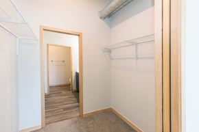 South Sioux City apartment for rent - a walk in closet with a mirror and a door to a room with a hallway