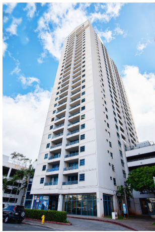 Honolulu apartment for rent - a tall white building with a blue sky behind it