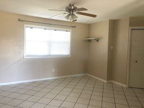 Snyder house for rent - an empty room with a ceiling fan and a window