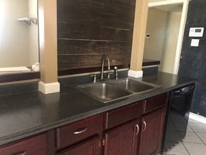 Snyder house for rent - a kitchen with a sink and a mirror
