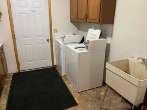 Leonard apartment for rent - A white door with a sign that says "No Trespassing" is in a room with a washer and dryer.