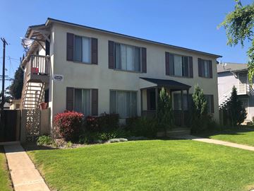 Long Beach apartment for rent - A white building with a balcony on the left side.