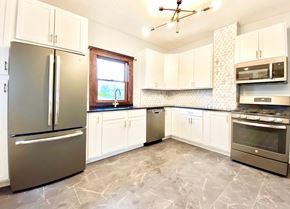 Lakewood house for rent - A kitchen with a refrigerator, oven, and microwave.