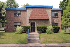 Pittsburgh apartment for rent - a brick house with a blue roof and stairs