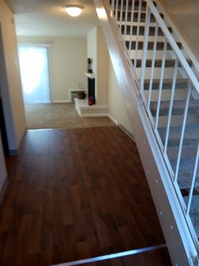 Portland apartment for rent - A long hallway with a staircase on the right and a door on the left.