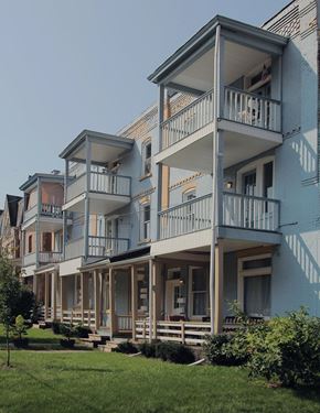 Pittsburgh apartment for rent - A row of houses with balconies and flower pots.