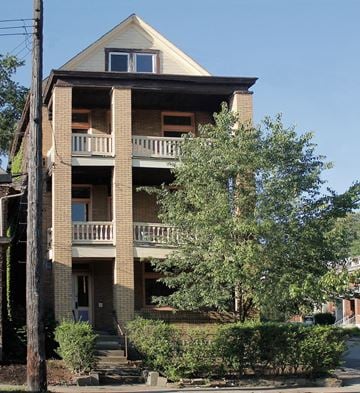 Pittsburgh apartment for rent - A two-story building with a balcony on the second floor.