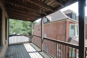 Pittsburgh apartment for rent - A wooden deck with a railing and a roof.