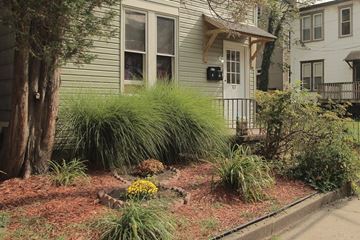 Pittsburgh apartment for rent - the front yard of a house with a garden and a sidewalk