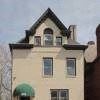 Pittsburgh apartment for rent - A beige house with a green awning.
