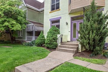 Pittsburgh apartment for rent - A house with a purple door and a green lawn.