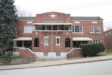 Swissvale apartment for rent - A red brick building with a white cross on the front.