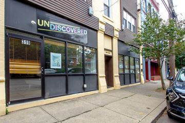 Pittsburgh apartment for rent - A storefront with the name UNDISCOVERED on the top of the windows.