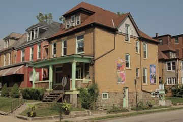Pittsburgh apartment for rent - a row of houses on the side of a street