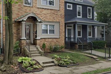 Pittsburgh apartment for rent - the front of a brick house with steps and a garden