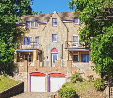 Pittsburgh apartment for rent - a large brick house with two garage doors