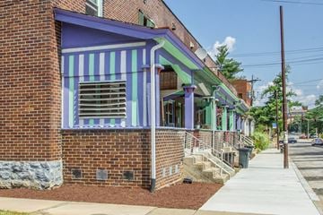 Pittsburgh apartment for rent - A building with a purple and green striped awning.