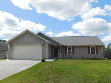 Hubert house for rent - A house with a grey roof and a white garage door.