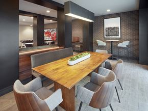 San Antonio apartment for rent - A modern dining room with a wooden table and grey chairs.