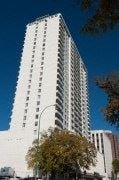 Winnipeg apartment for rent - A tall white building with a lot of windows.