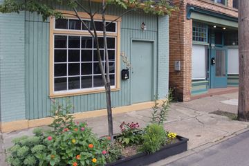 Pittsburgh apartment for rent - A green building with a tree in front of it.