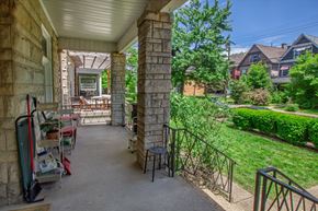 Pittsburgh apartment for rent - A patio with a table and chairs is surrounded by a stone wall.